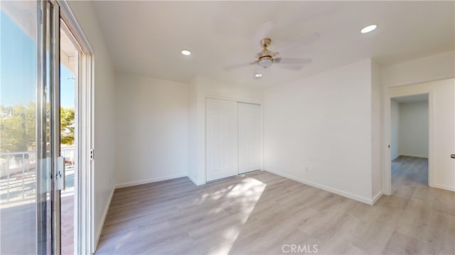 spare room featuring light hardwood / wood-style floors and ceiling fan