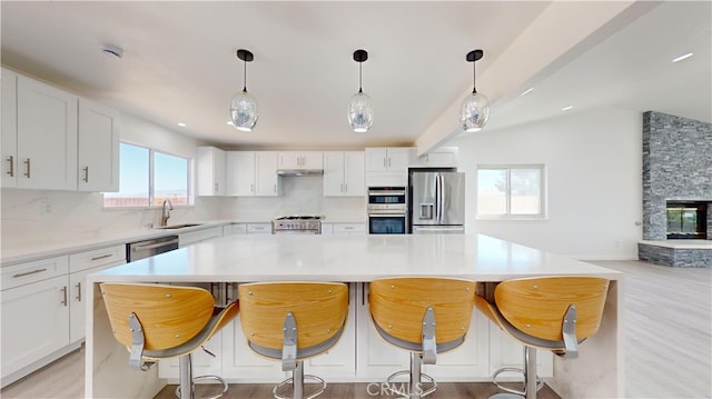 kitchen featuring white cabinets, sink, and stainless steel appliances