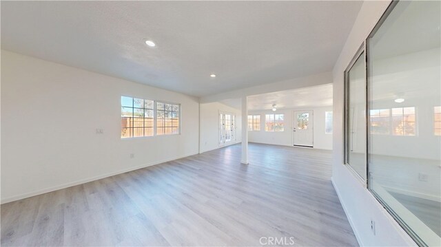 spare room with ceiling fan and light hardwood / wood-style flooring