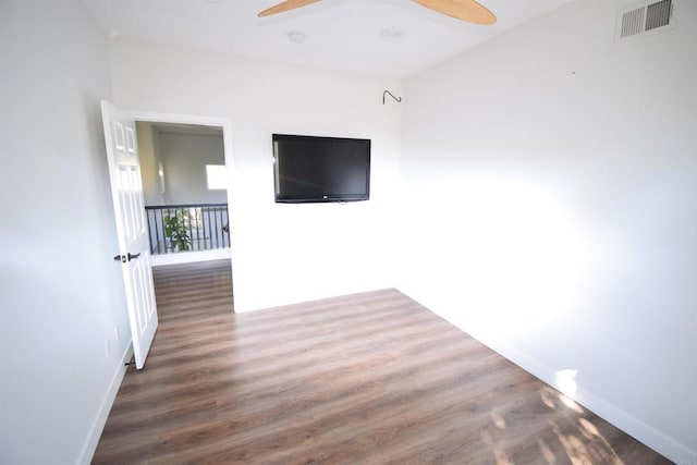 unfurnished living room with ceiling fan and dark hardwood / wood-style flooring