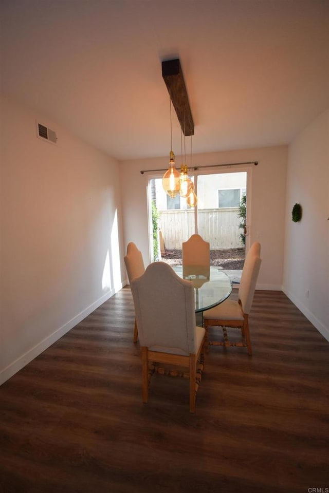 dining area featuring beam ceiling and dark wood-type flooring