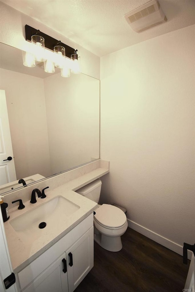 bathroom featuring hardwood / wood-style flooring, vanity, and toilet