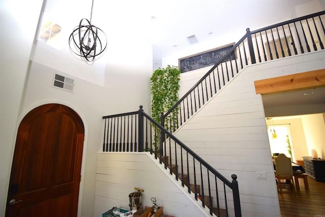 foyer with hardwood / wood-style flooring and a high ceiling