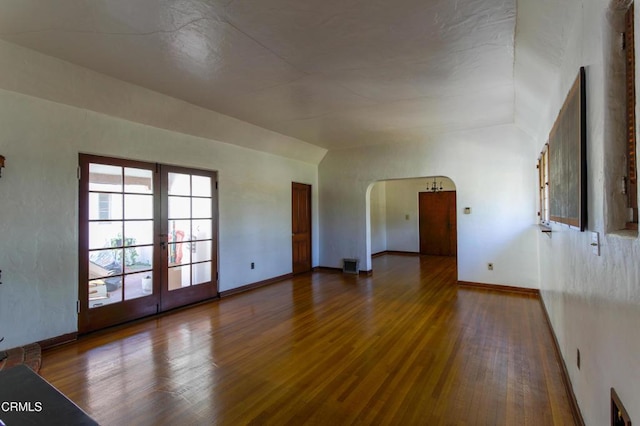 empty room with hardwood / wood-style floors and french doors