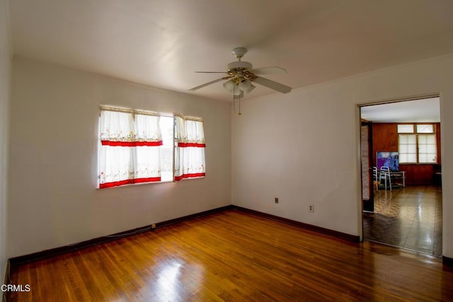 spare room with ceiling fan and dark wood-type flooring