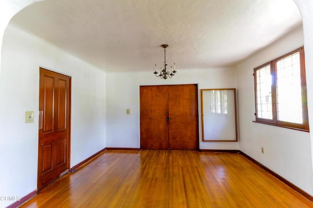 interior space featuring a chandelier and hardwood / wood-style floors