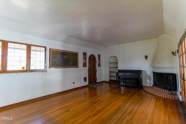 unfurnished living room with a fireplace and hardwood / wood-style flooring