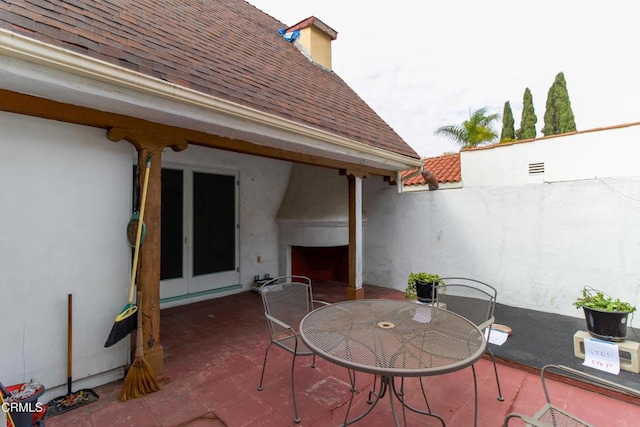 view of patio with a fireplace