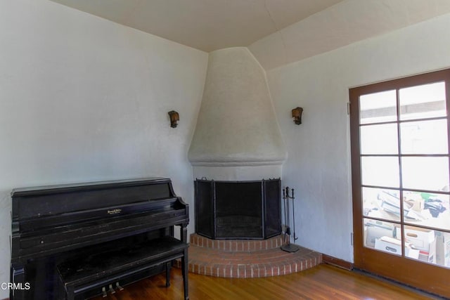 misc room with wood-type flooring and a fireplace