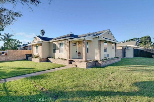 ranch-style home with a front lawn