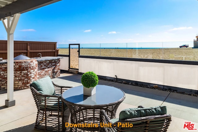 view of patio featuring a water view