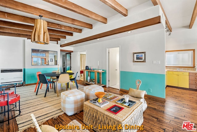 living room featuring beamed ceiling, dark wood-type flooring, and heating unit