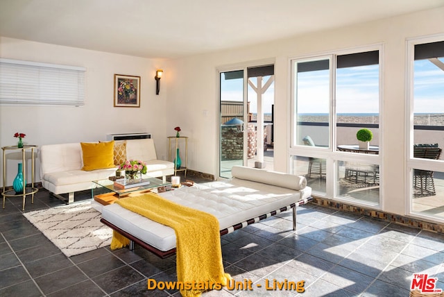 tiled living room with a water view