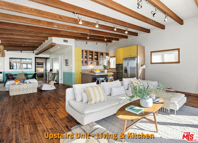 living room featuring beam ceiling and dark wood-type flooring