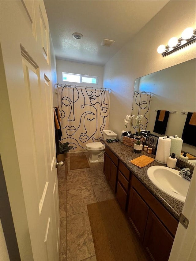 bathroom with walk in shower, vanity, and toilet