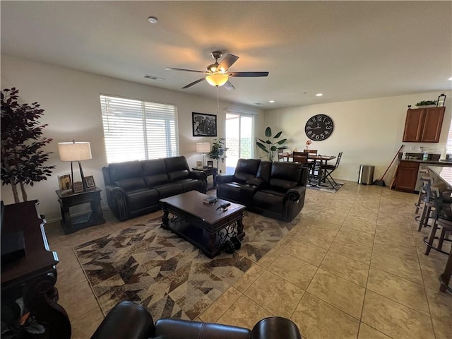 tiled living room with ceiling fan