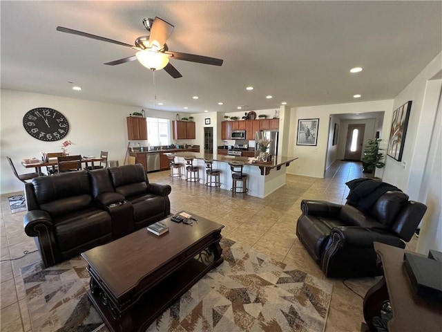 tiled living room featuring ceiling fan