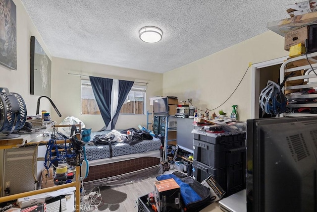 bedroom with hardwood / wood-style floors and a textured ceiling