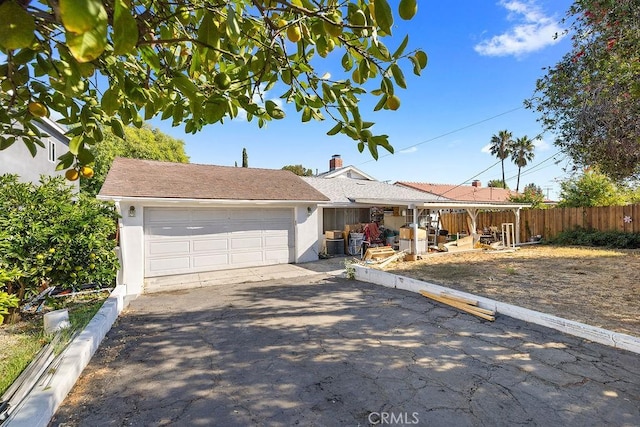 ranch-style home with central AC and a garage