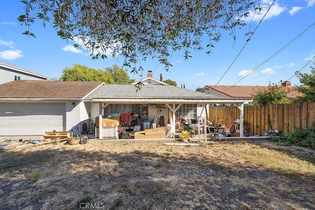 back of house with a garage