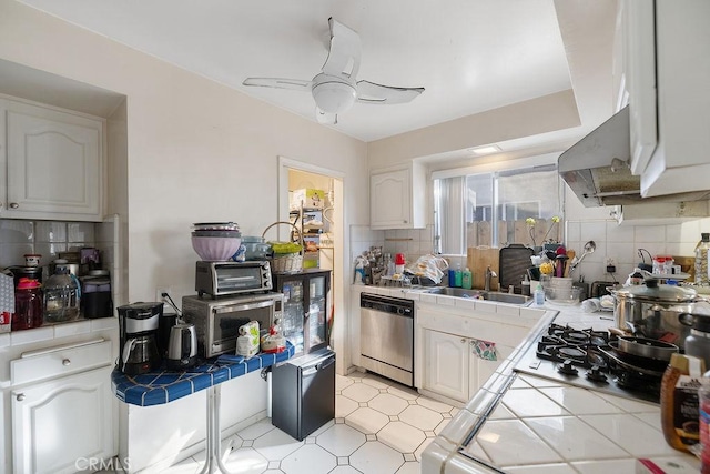 kitchen with backsplash, tile countertops, white cabinetry, and stainless steel dishwasher