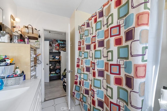 bathroom with hardwood / wood-style floors, a shower with curtain, and a textured ceiling