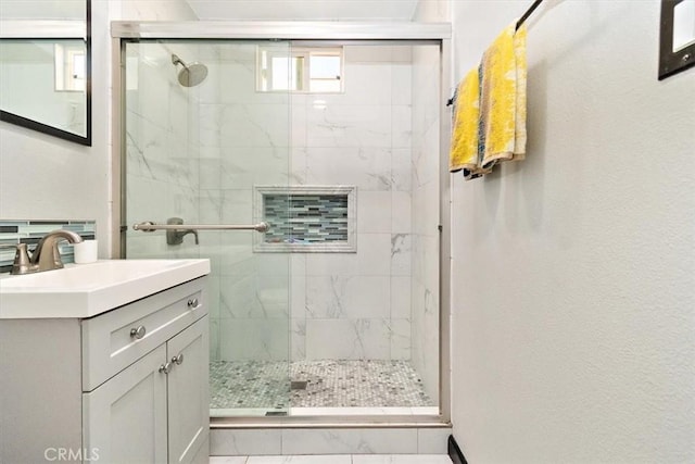 bathroom featuring vanity and a shower with shower door