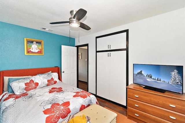 bedroom featuring ceiling fan and dark hardwood / wood-style floors