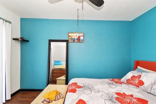 bedroom featuring ceiling fan and dark hardwood / wood-style flooring