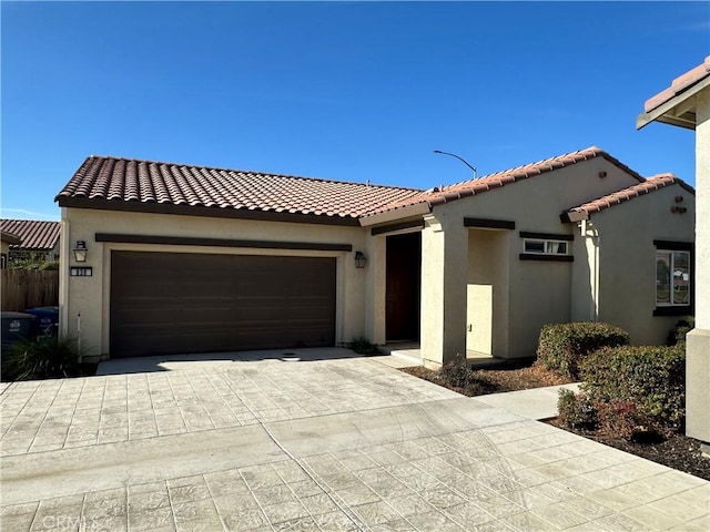 mediterranean / spanish-style house with a garage