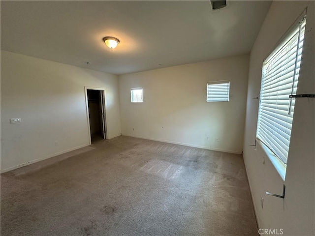 spare room with carpet and plenty of natural light