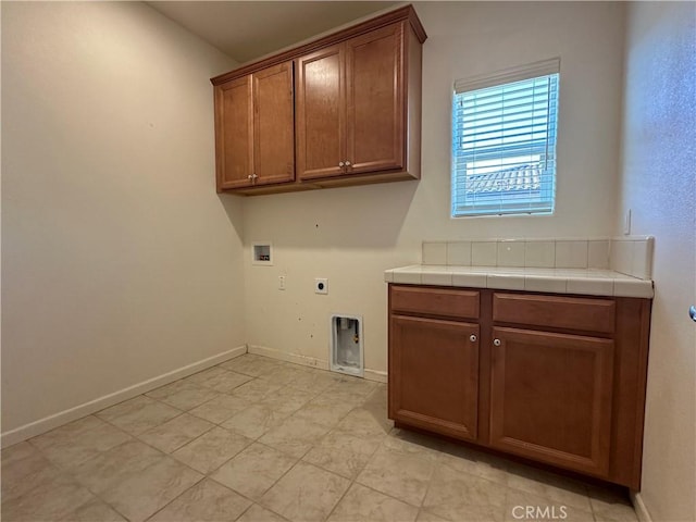 laundry room featuring cabinets, hookup for a washing machine, and hookup for an electric dryer