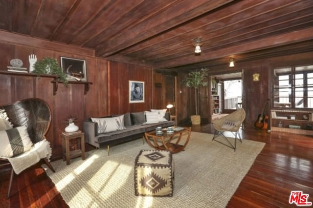 interior space with dark hardwood / wood-style flooring, wooden ceiling, and wood walls