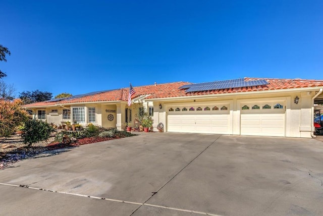 view of front of house featuring solar panels and a garage