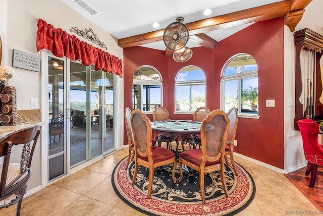 tiled dining room with beam ceiling