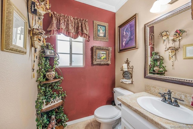 bathroom featuring tile patterned flooring, vanity, ornamental molding, and toilet