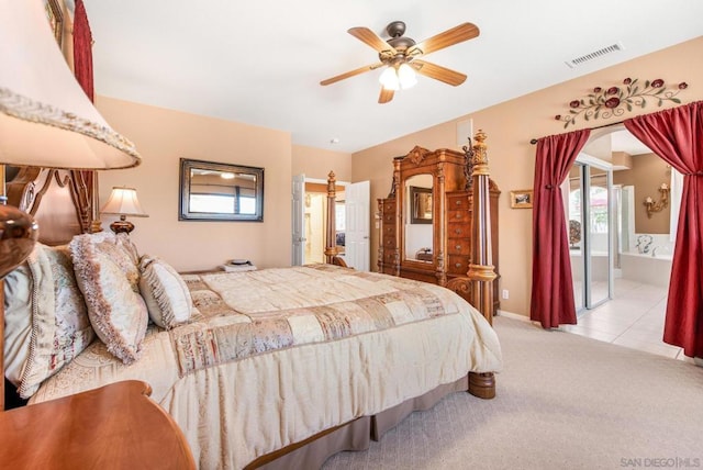 carpeted bedroom with ceiling fan and connected bathroom