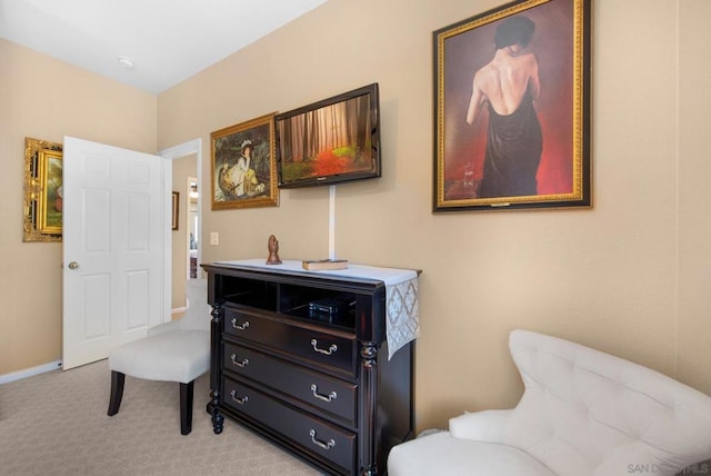 sitting room featuring light colored carpet