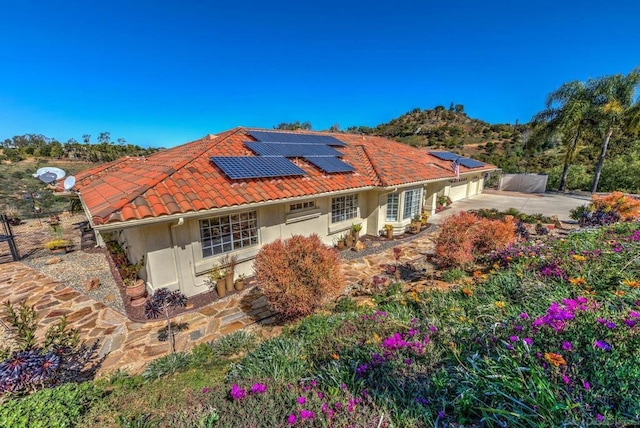 back of property featuring solar panels