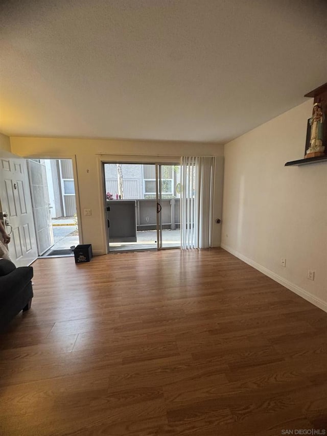 unfurnished living room featuring dark hardwood / wood-style floors