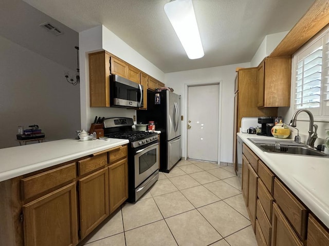 kitchen featuring sink, light tile patterned floors, and stainless steel appliances