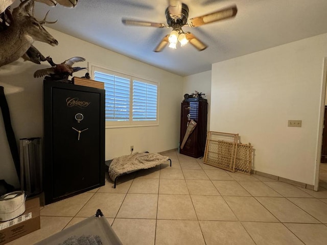 unfurnished bedroom featuring ceiling fan and light tile patterned floors