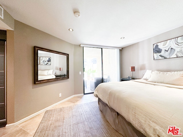 bedroom featuring access to outside and light tile patterned flooring