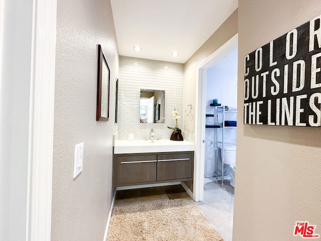 bathroom featuring vanity and toilet