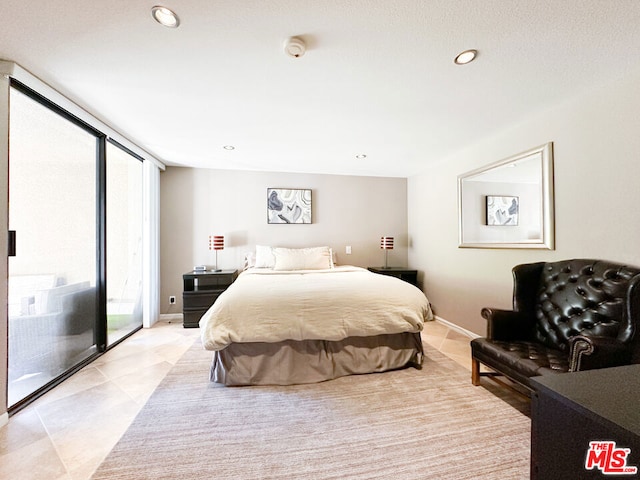 bedroom featuring access to outside and floor to ceiling windows