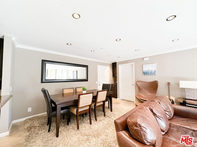 dining area featuring light tile patterned flooring and ornamental molding