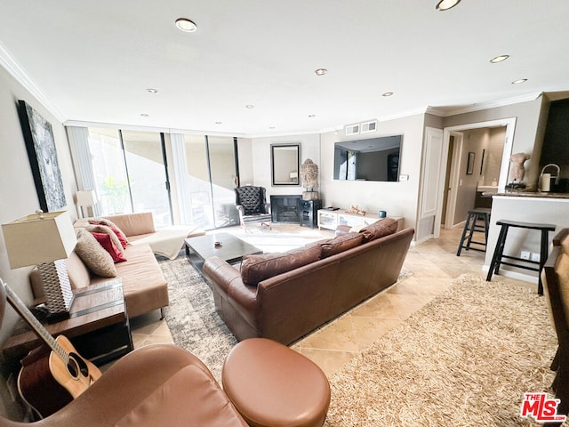 living room featuring light tile patterned floors and ornamental molding