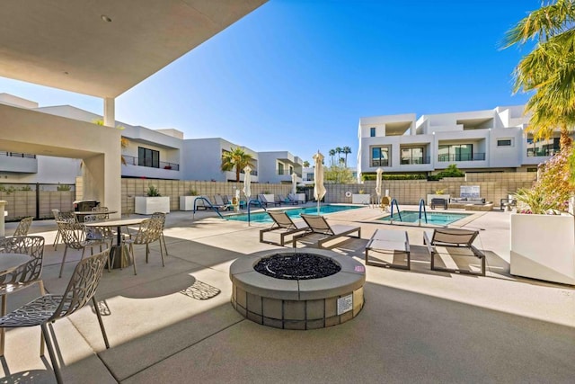 view of patio / terrace with a community pool and a fire pit