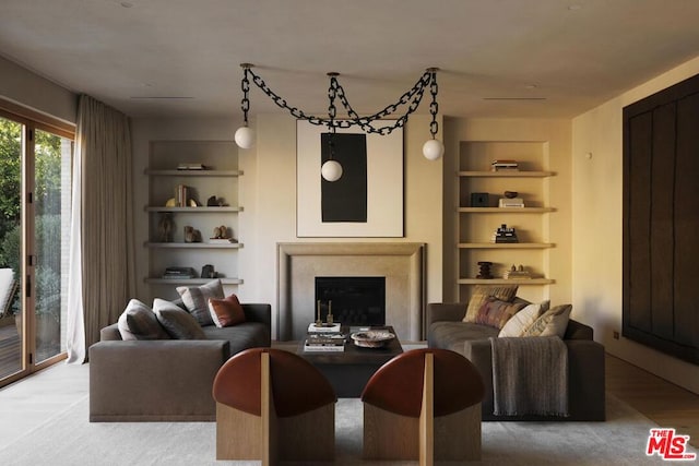 living room with built in shelves and hardwood / wood-style flooring