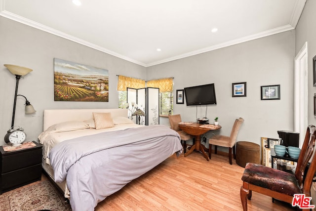 bedroom featuring light hardwood / wood-style flooring and ornamental molding